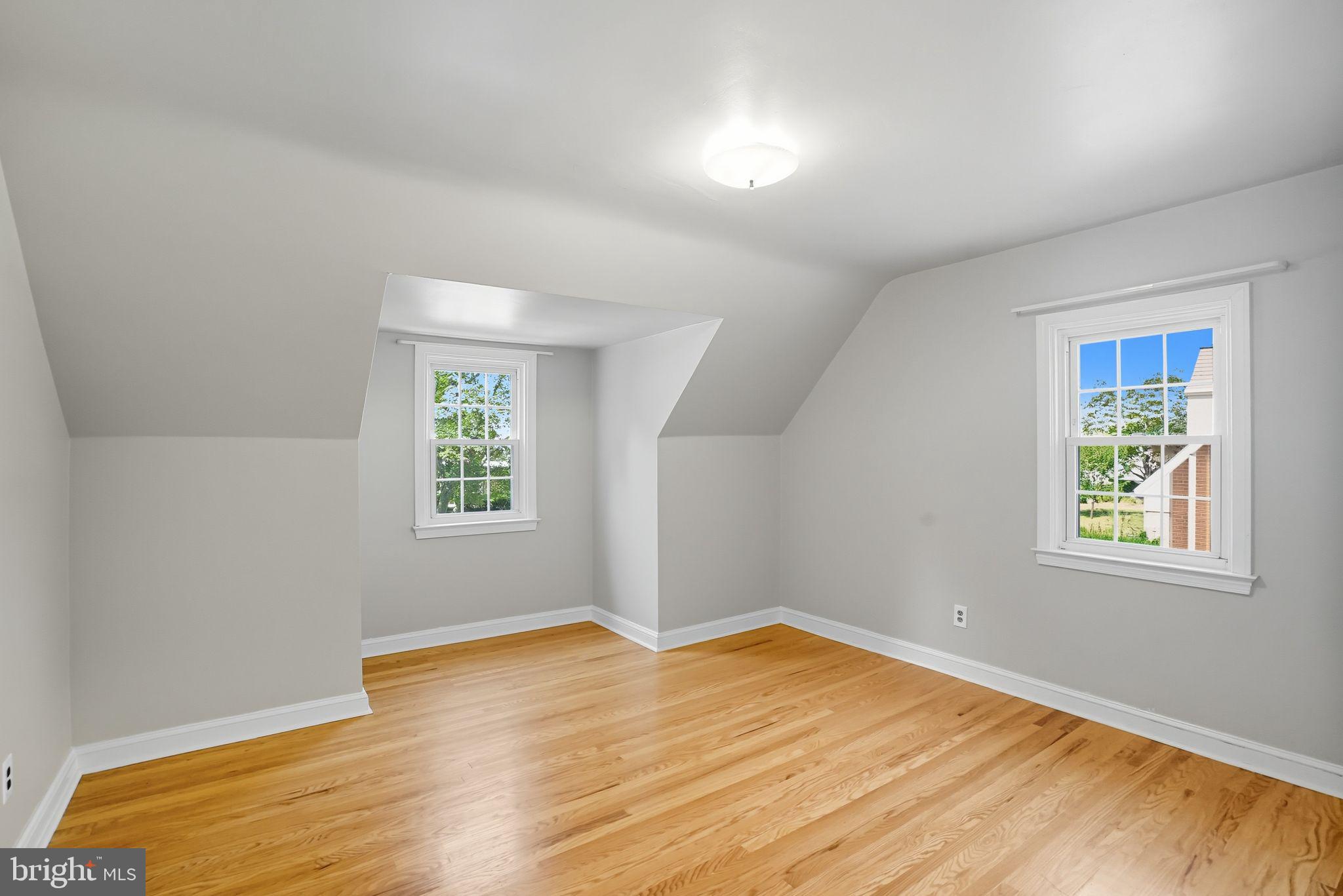 979 Edgewood Drive Springfield, PA 19064 - Photo 24 of 36 an empty room with wooden floor and windows