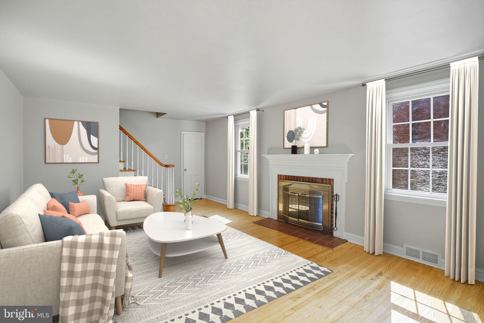 979 Edgewood Drive Springfield, PA 19064 - Photo 6 of 36 a living room with furniture a window and a fireplace