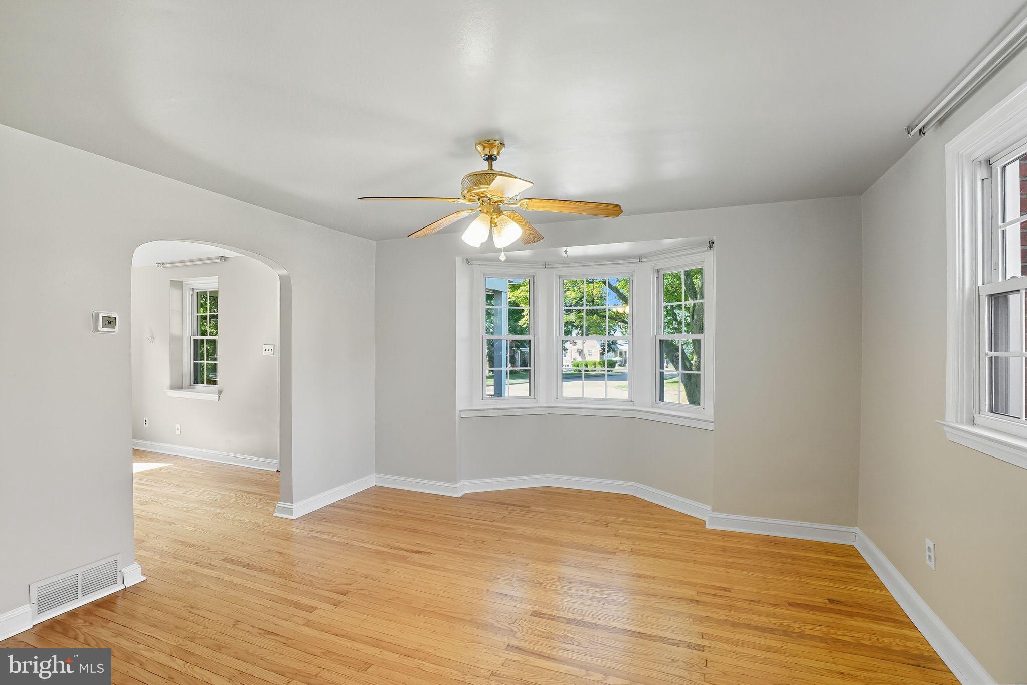 979 Edgewood Drive Springfield, PA 19064 - Photo 10 of 36 a view of an empty room with wooden floor and a window