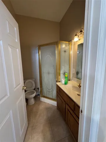 a bathroom with a granite countertop sink a toilet and a tub