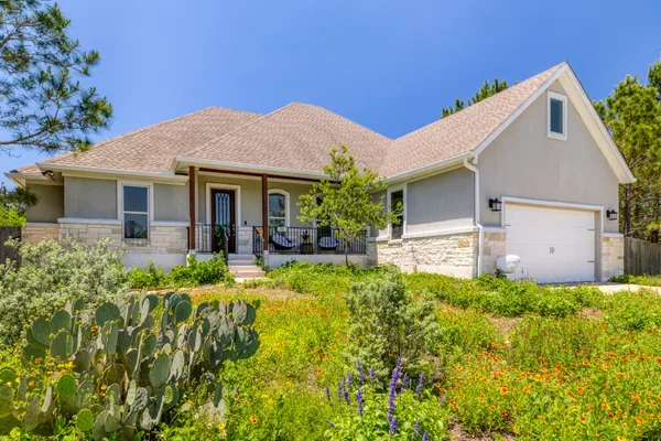 a view of a house with pool and plants