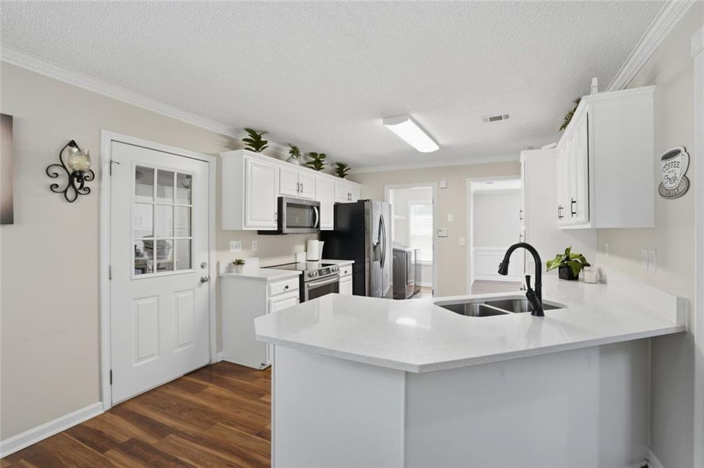 3675 Falls Trail Winston, GA 30187 - Photo 13 of 47 a kitchen with stainless steel appliances granite countertop a sink a stove and cabinets