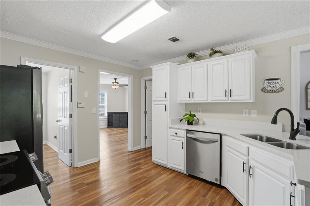 3675 Falls Trail Winston, GA 30187 - Photo 14 of 47 a kitchen with white cabinets and wooden floors