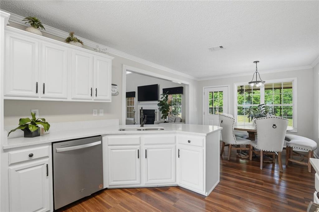 3675 Falls Trail Winston, GA 30187 - Photo 15 of 47 a kitchen with a sink cabinets and wooden floor