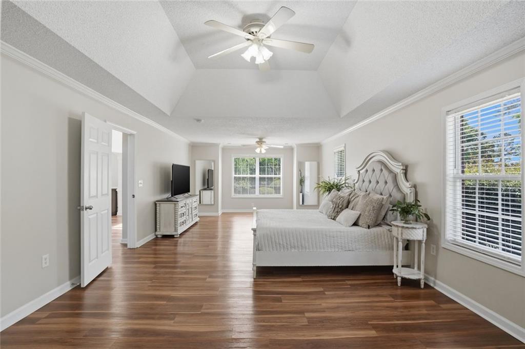 3675 Falls Trail Winston, GA 30187 - Photo 20 of 47 a bedroom with a large bed and a chandelier