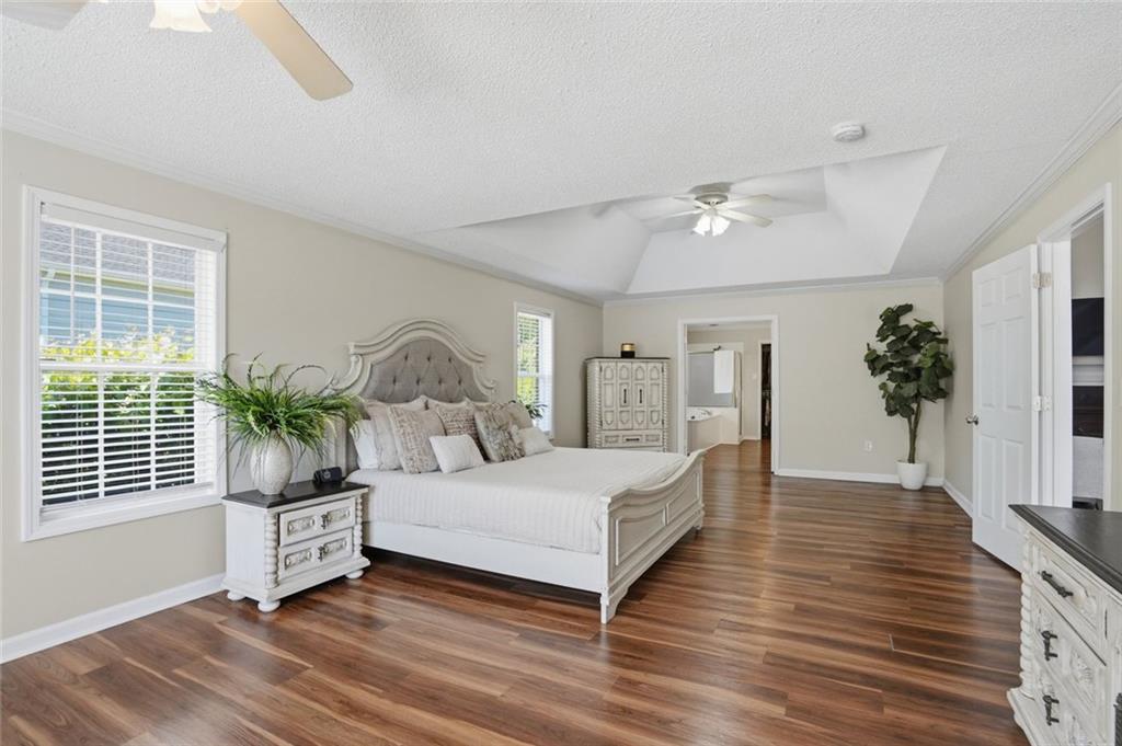 3675 Falls Trail Winston, GA 30187 - Photo 21 of 47 a bedroom with a large bed and a potted plant