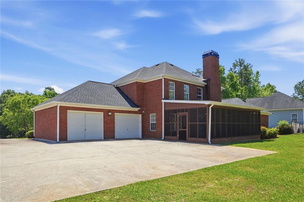 3675 Falls Trail Winston, GA 30187 - Photo 36 of 47 a front view of a house with a yard and garage