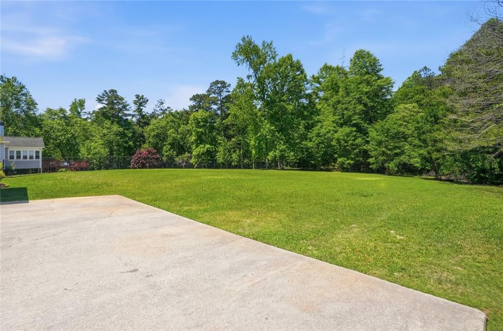 3675 Falls Trail Winston, GA 30187 - Photo 39 of 47 a view of a garden with a building in the background