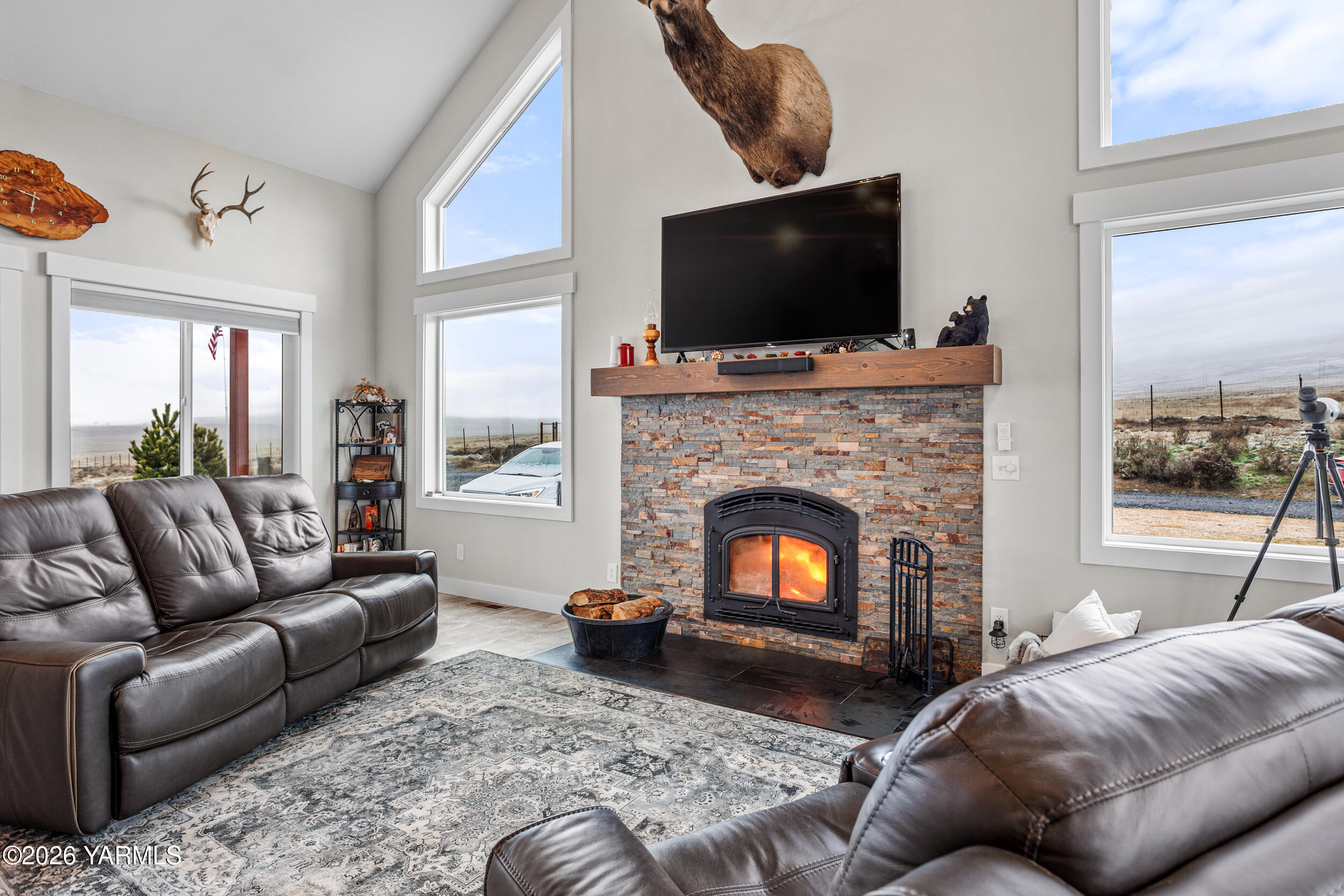 517 Game Ridge Road Selah, WA 98942 - Photo 12 of 72 a living room with furniture a flat screen tv and a fireplace