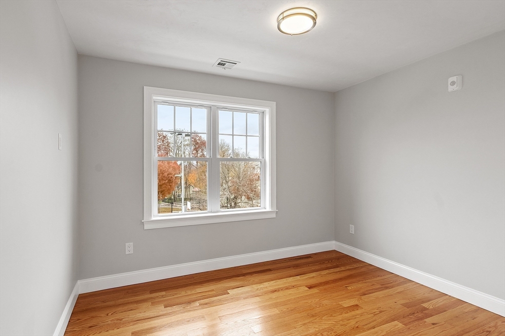 10 Windsor Street Worcester, MA 01605 - Photo 19 of 26 a view of an empty room with wooden floor and a window
