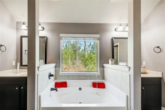 a white bath tub sitting next to a white sink