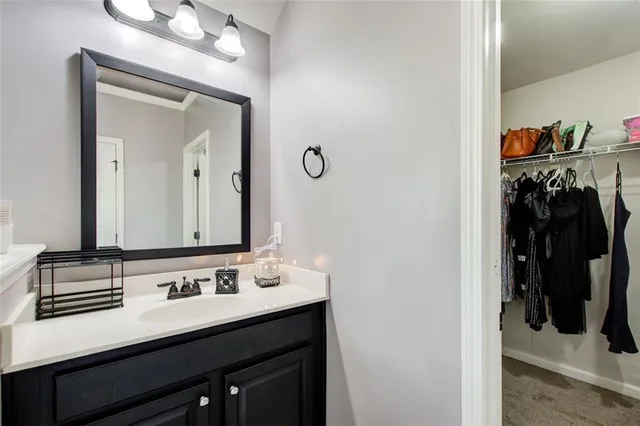 a bathroom with a sink vanity and a mirror
