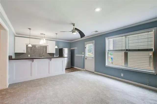 a view of a kitchen with a sink and dishwasher cabinets