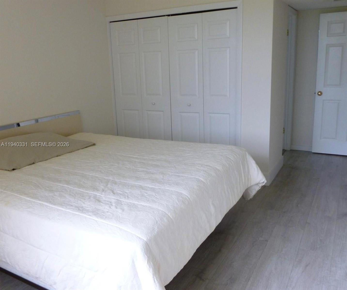 16300 Golf Club Road, Unit 203 Weston, FL 33326 - Photo 7 of 11 a bedroom with a bed and a window