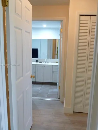 a large bathroom with a large mirror and a sink