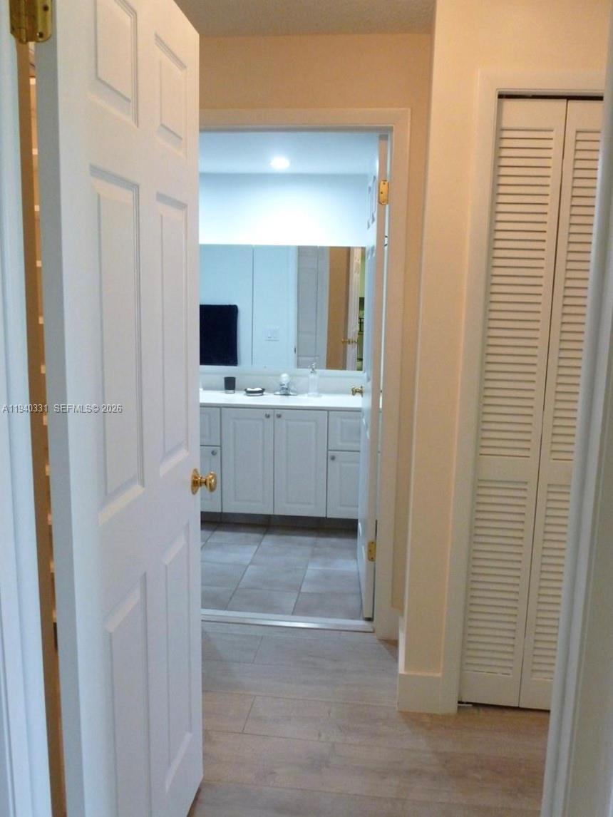 16300 Golf Club Road, Unit 203 Weston, FL 33326 - Photo 9 of 11 a large bathroom with a large mirror and a sink