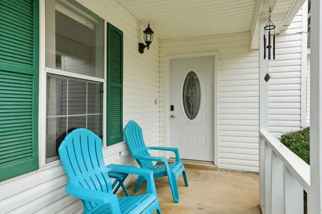 a view of a two chairs in the balcony