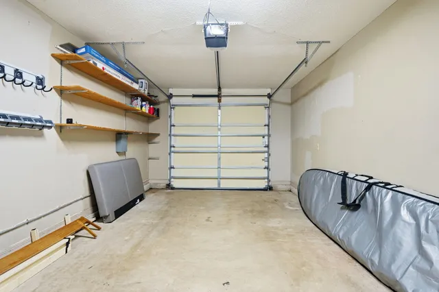 a backyard of a house with plants and wooden fence