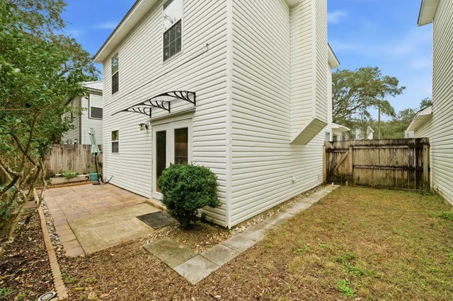 an aerial view of residential houses with outdoor space and trees