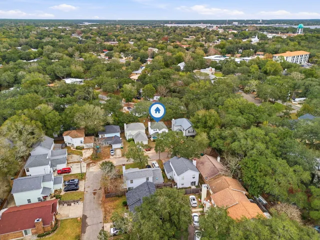 an aerial view of a house with a yard
