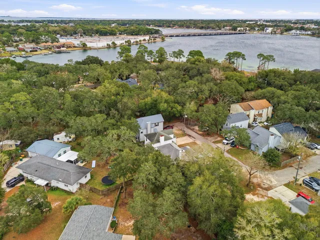 an aerial view of a houses with outdoor space and lake view