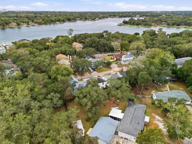 an aerial view of a houses with a lake