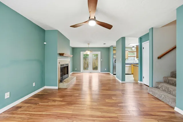 a view of an empty room with window and fire place