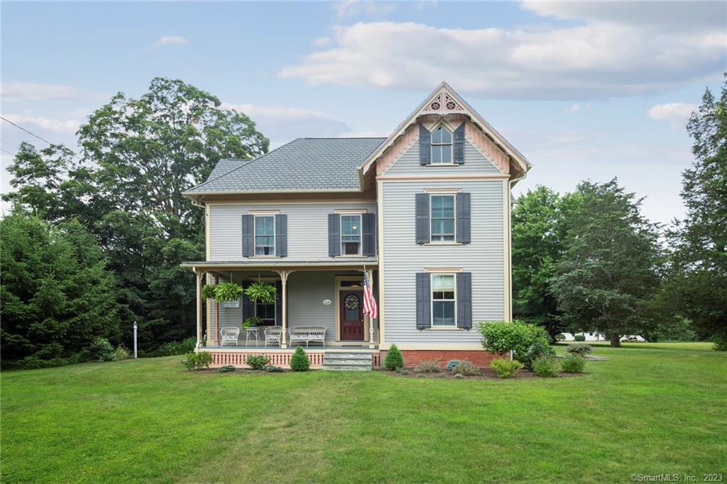 a front view of house with yard and green space