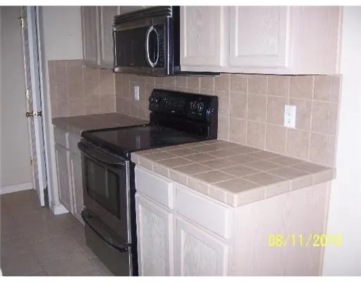 a kitchen with a stove and a microwave