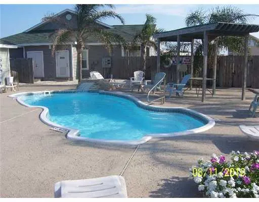 an outdoor space with swimming pool and furniture