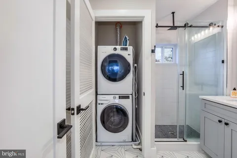 a bathroom with a toilet sink vanity and mirror