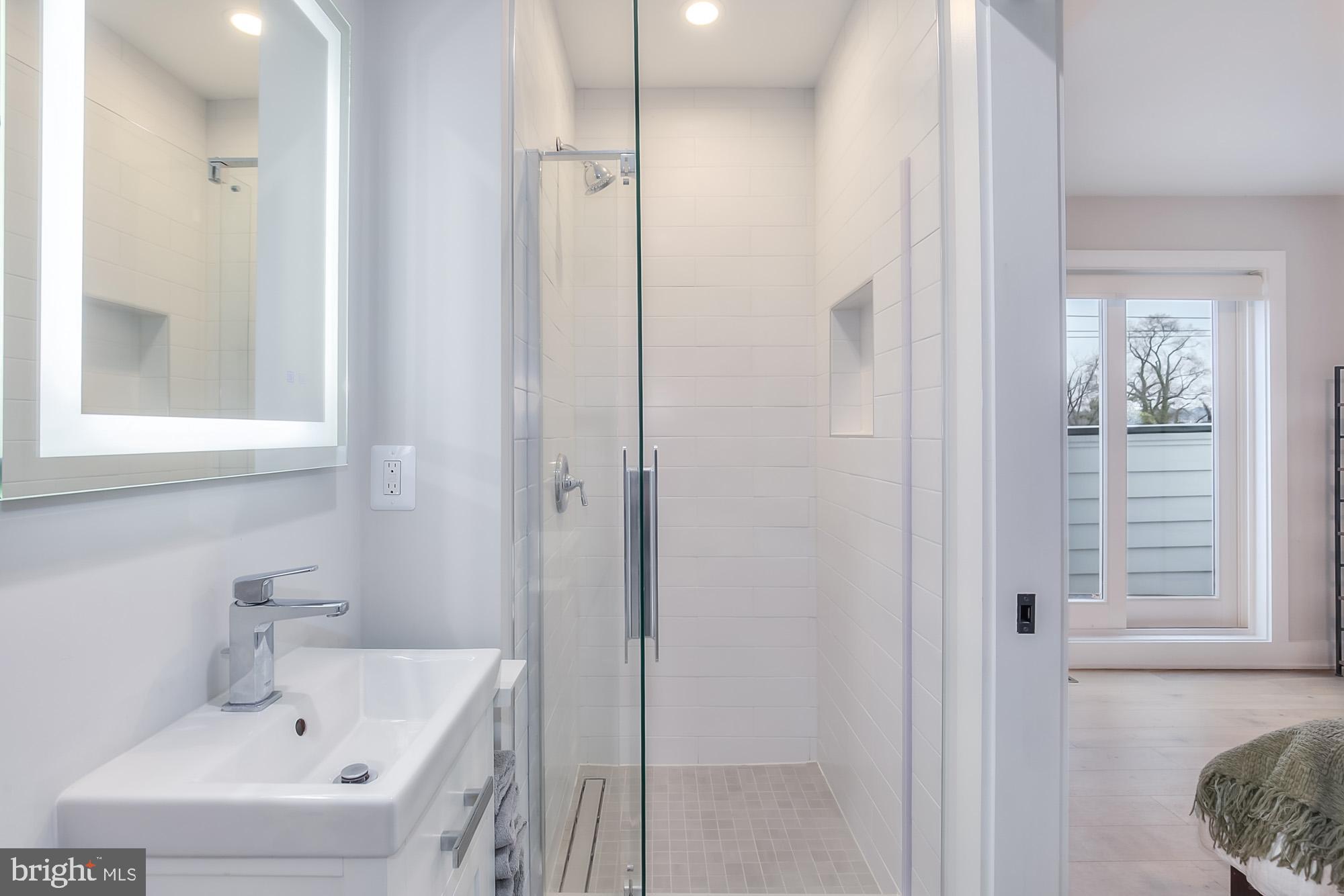501 Longfellow Street Northwest, Unit B Washington, DC 20011 - Photo 17 of 22 a bathroom with a sink and a mirror