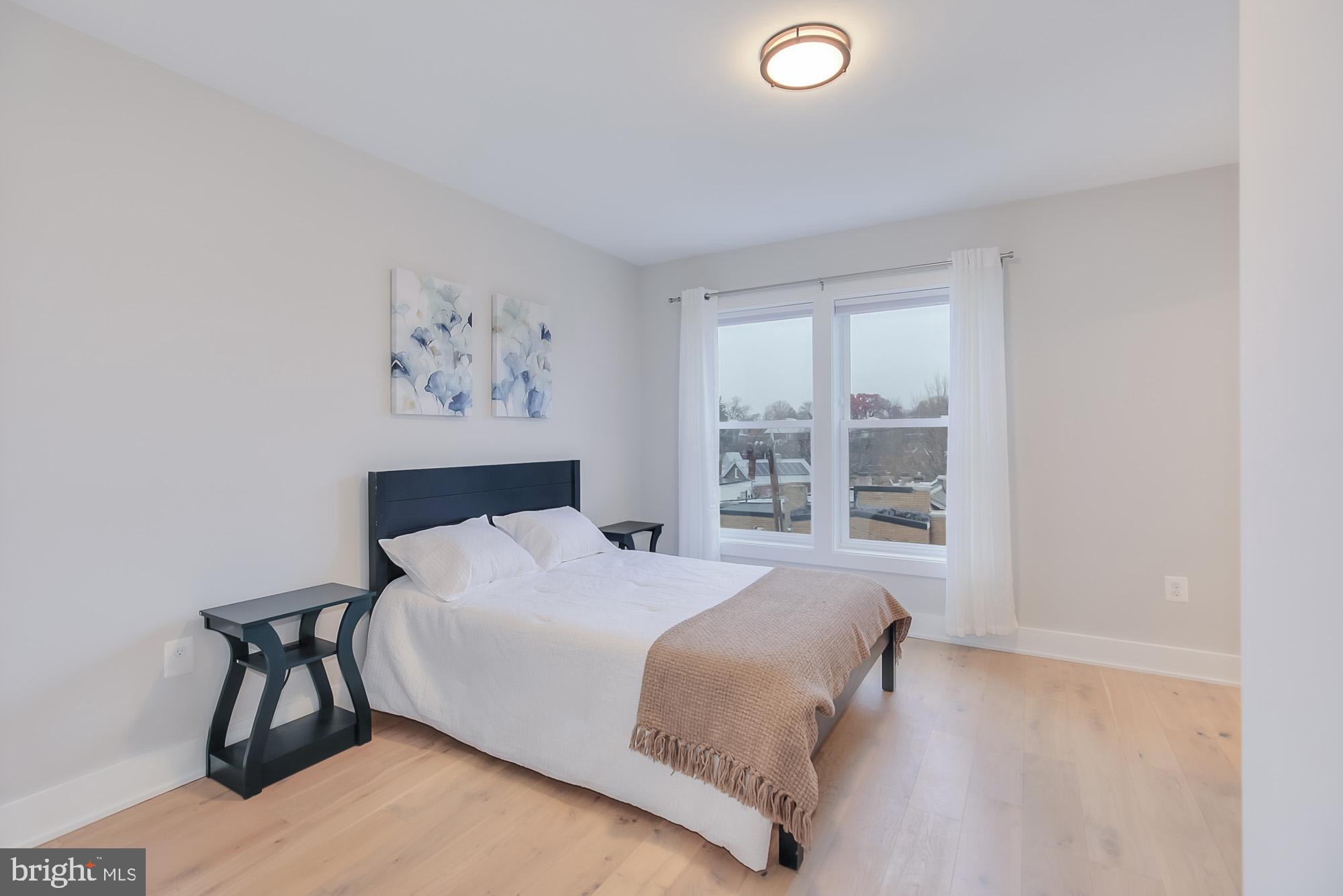 501 Longfellow Street Northwest, Unit B Washington, DC 20011 - Photo 18 of 22 a bedroom with a bed and a window