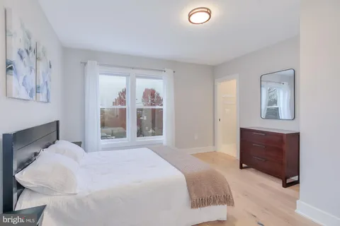 a bathroom with a sink vanity mirror and toilet