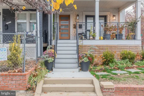 a view of a house with potted plants