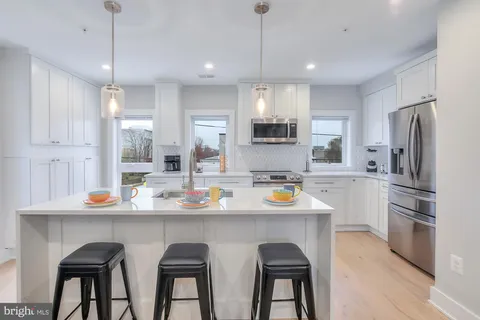 a kitchen with stainless steel appliances a sink stove and refrigerator