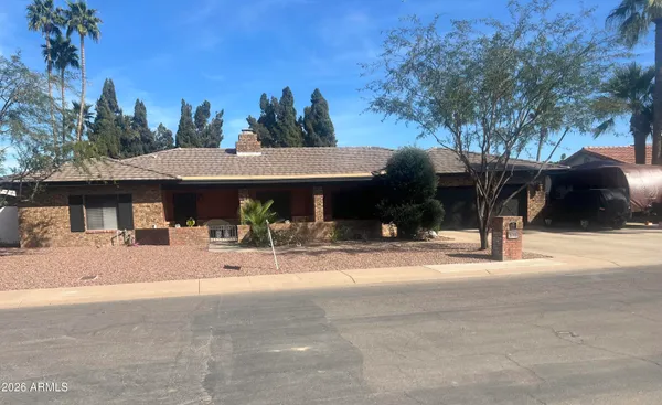 a view of a house with palm trees and a front view of a house