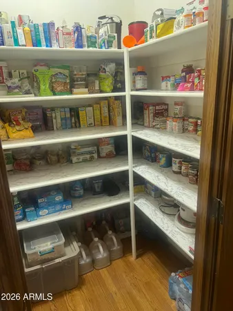a cabinet with granite countertop lots of different kinds of food