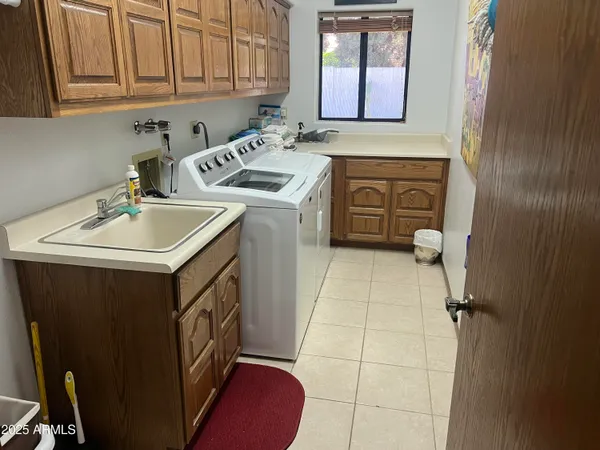 a utility room with a sink washer and dryer