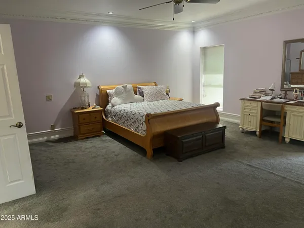 a spacious bedroom with a bed and a couch