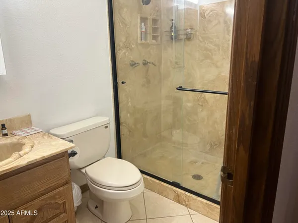 a white toilet sitting next to a bathroom sink