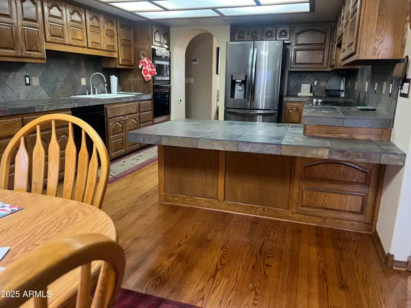 a view of kitchen and island with wooden floor