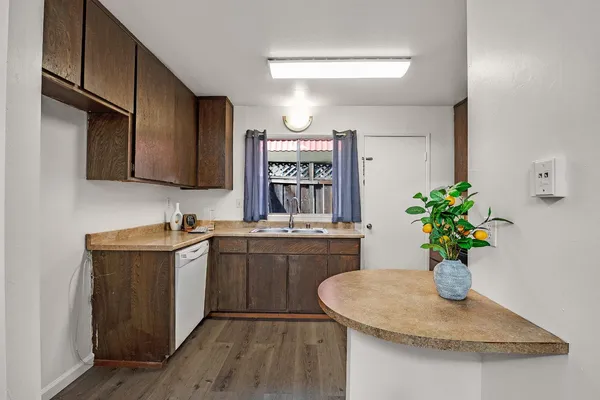 a kitchen with a sink and dishwasher cabinets