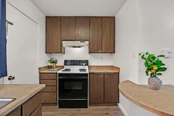 a kitchen with a stove and a refrigerator