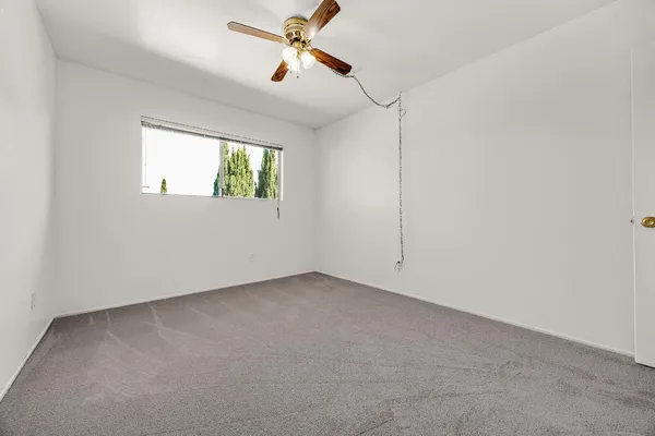 a view of room with window and ceiling fan