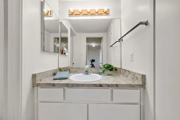 a bathroom with a sink and a mirror