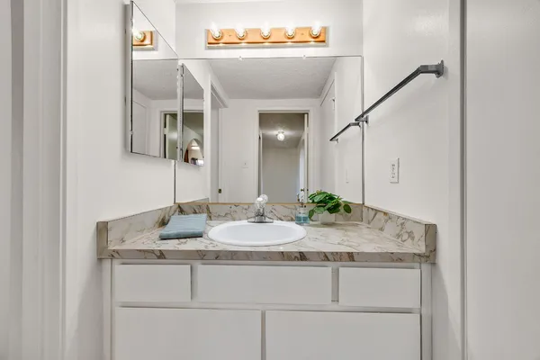 a bathroom with a sink and a mirror