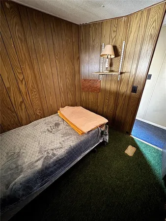 a bed sitting in a bedroom next to a wooden floor