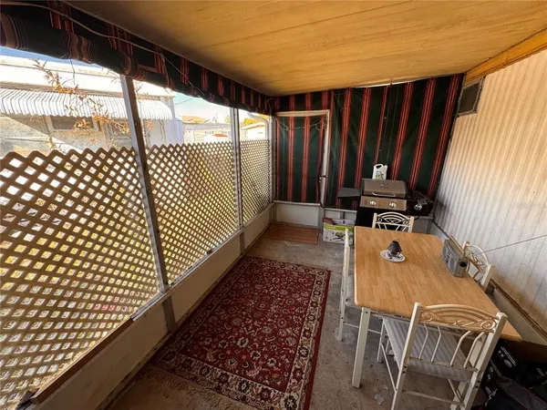 a view of a balcony with wooden floor