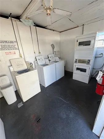 a white kitchen with sink stove and refrigerator